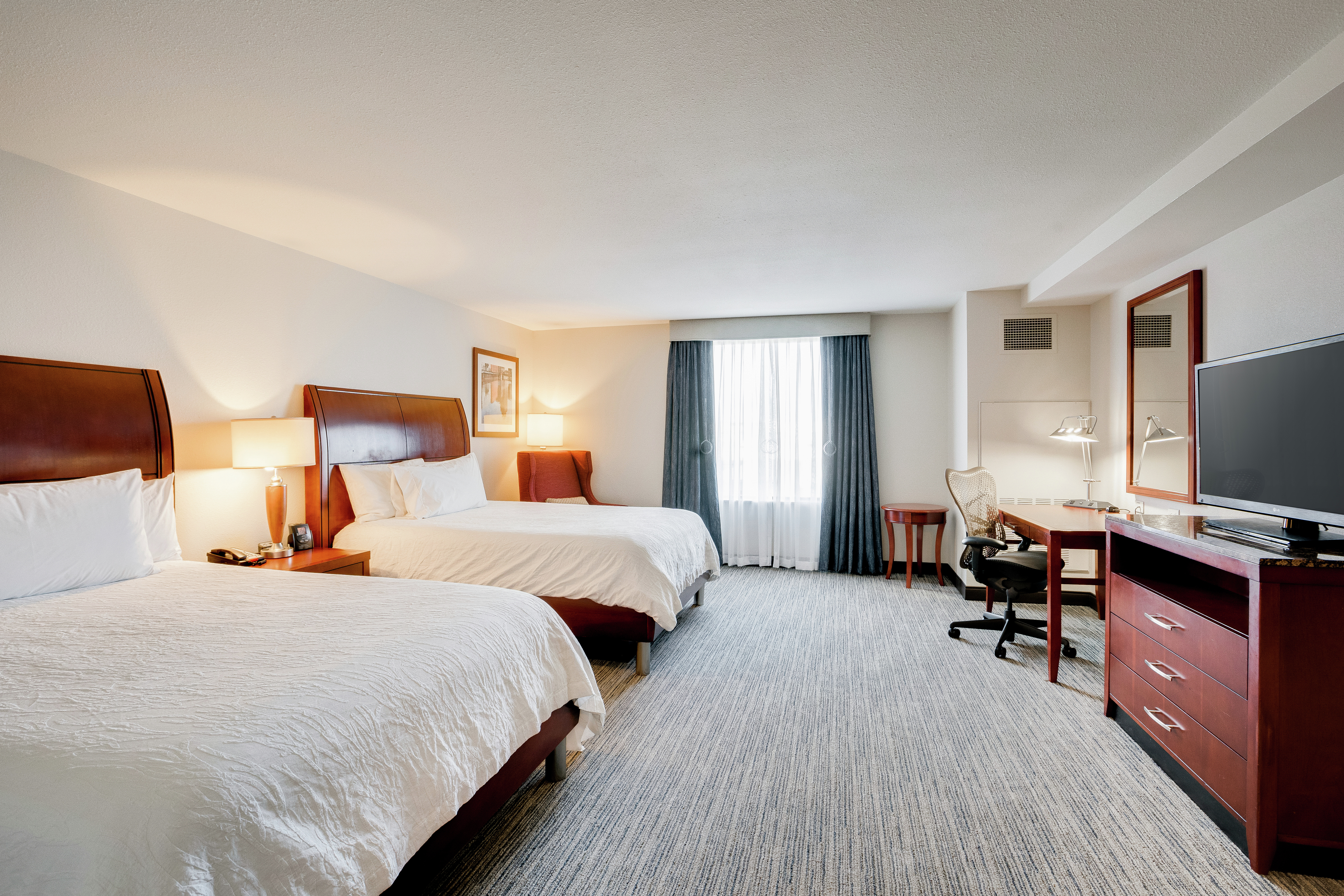 Two Queen Beds, Flat Screen TV, and Work Desk with Chair in Accessible Guest Room