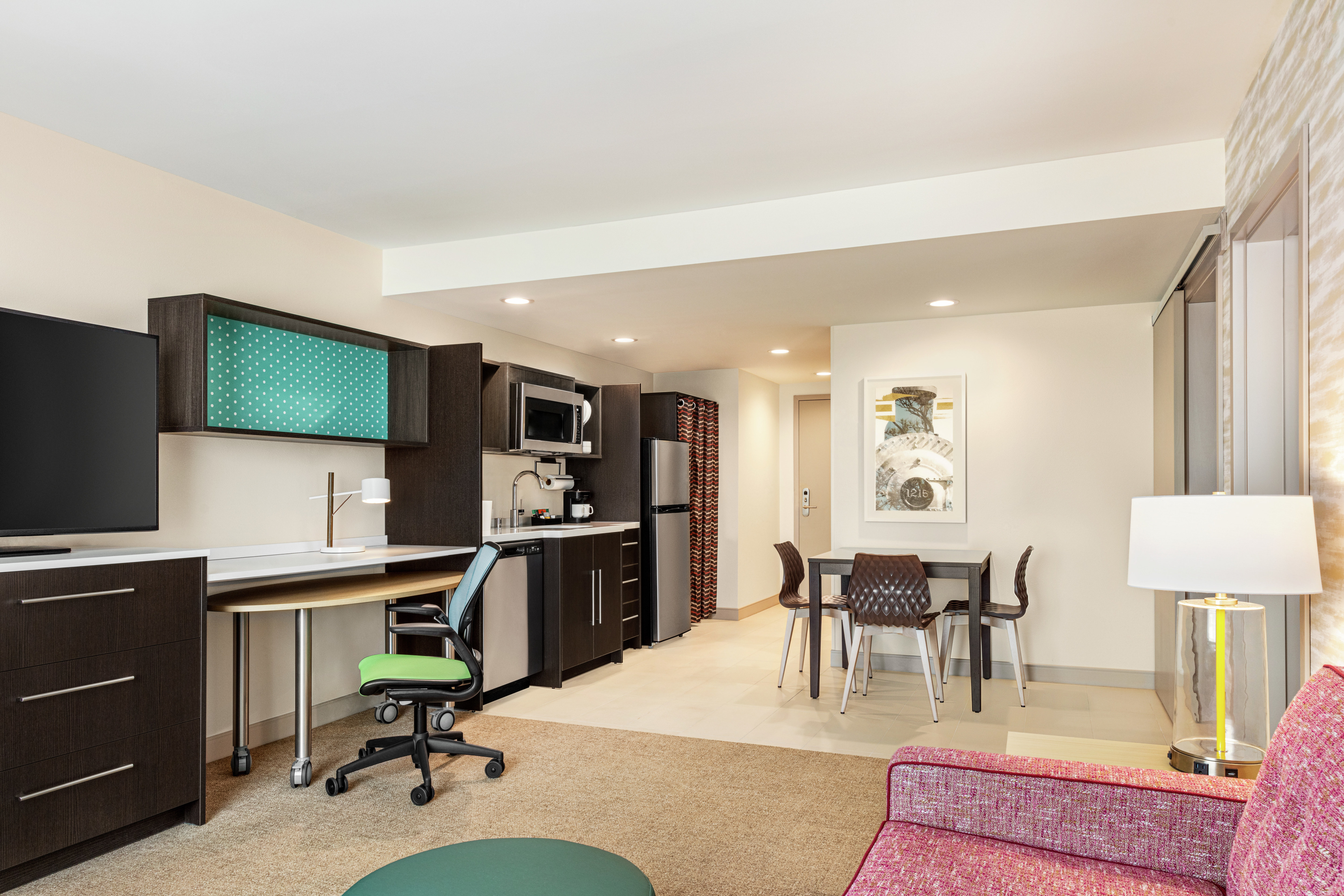 Beautiful guest suite with a convenient kitchen, dining table and work desk for guests enjoyment