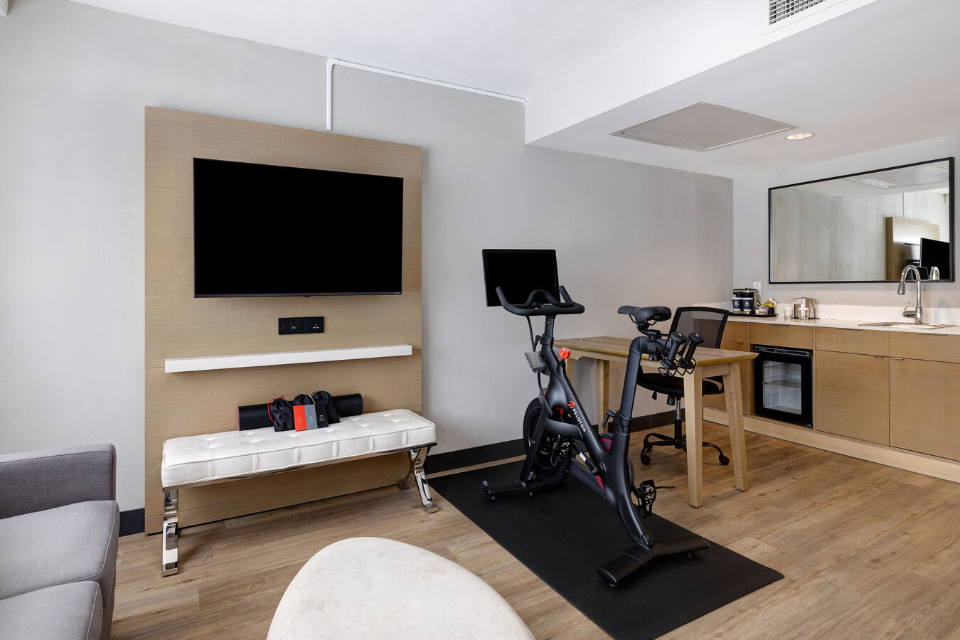 guest room wtih tv wet bar and exercise machine
