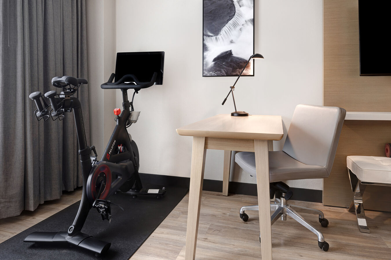 guest room with work desk and exercise machine