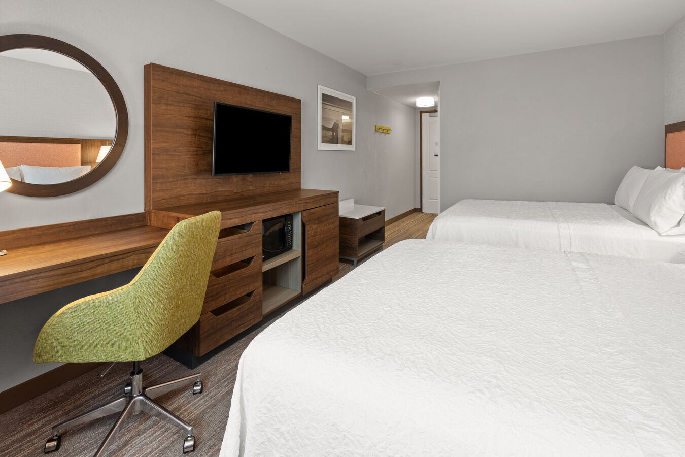 Two queen bed guest room with large screen TV