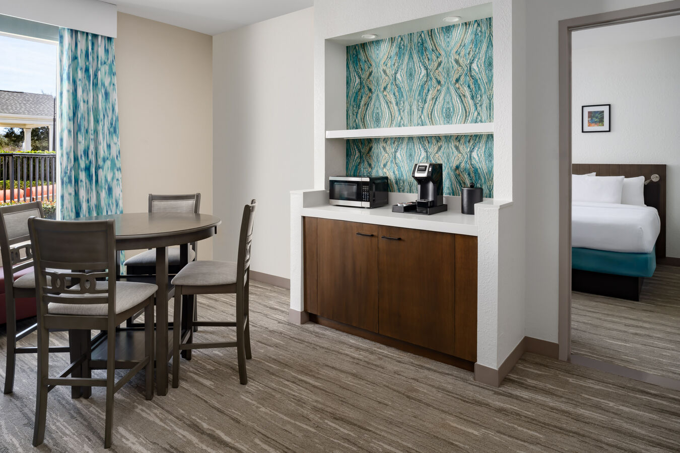 The dining table and beverage station in a suite.