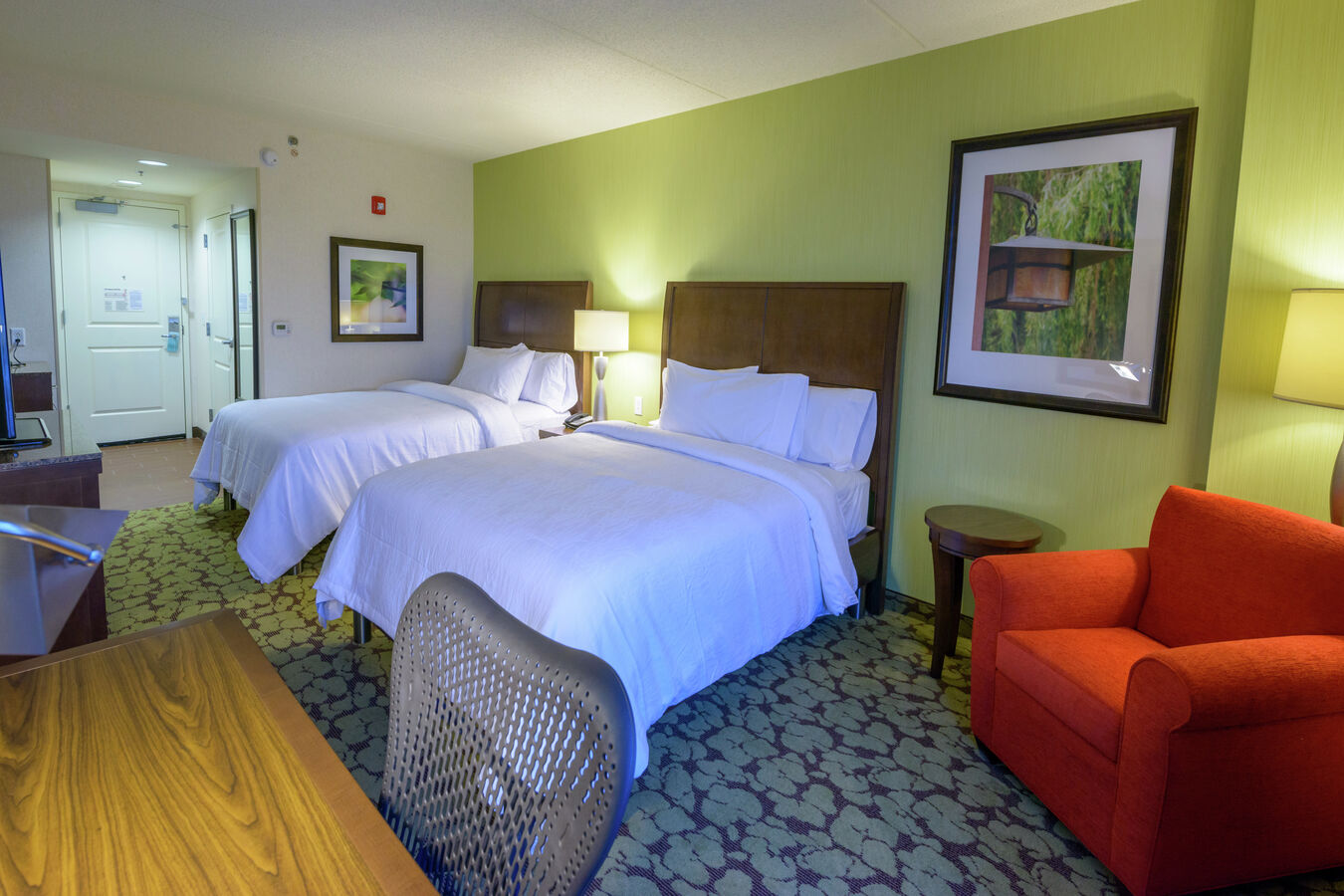 Accessible Double Queen Guestroom with Bed, Lounge Area, and Work Desk