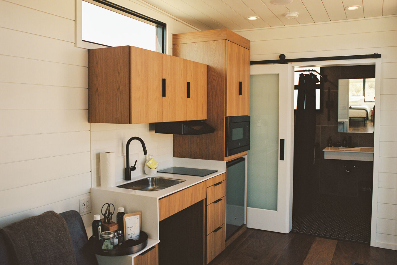 Accommodation interior with sink, microwave and fridge