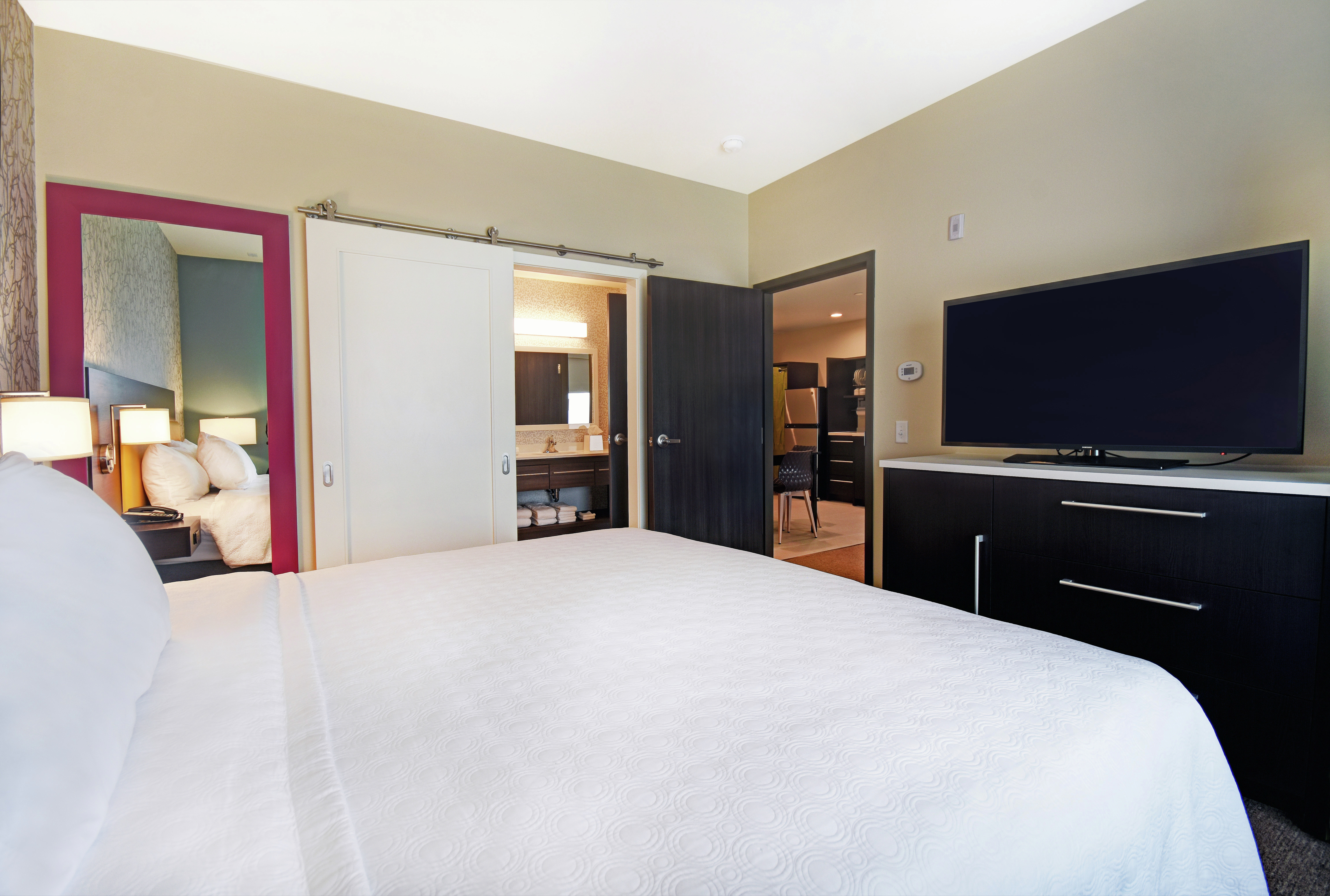 Suite Bedroom with King Bed TV and Entry to Living Area