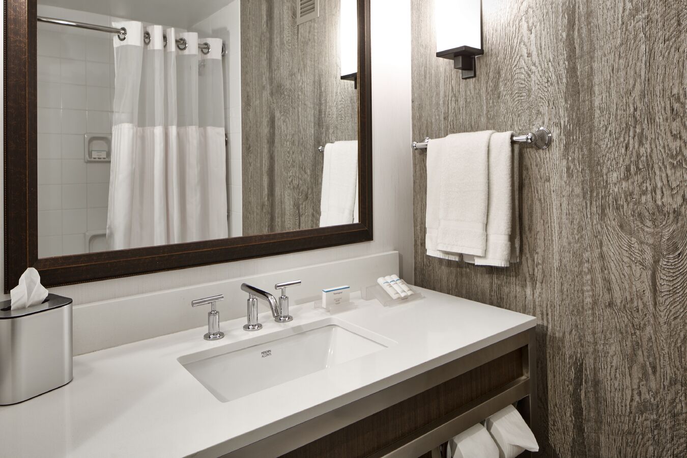 Bathroom Vanity Area with Large Mirror and Shower