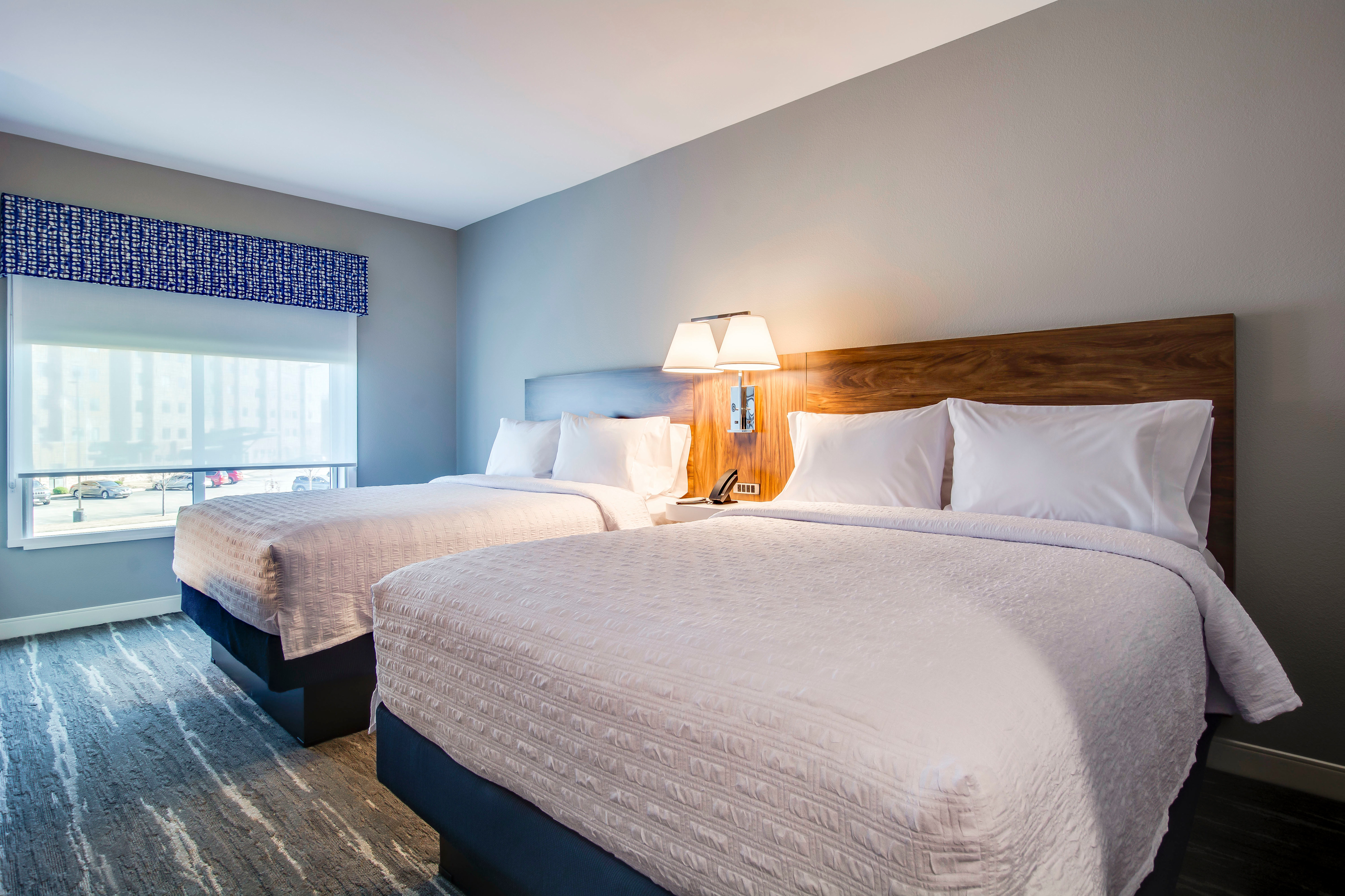 Queen guest room with two beds and nightstand