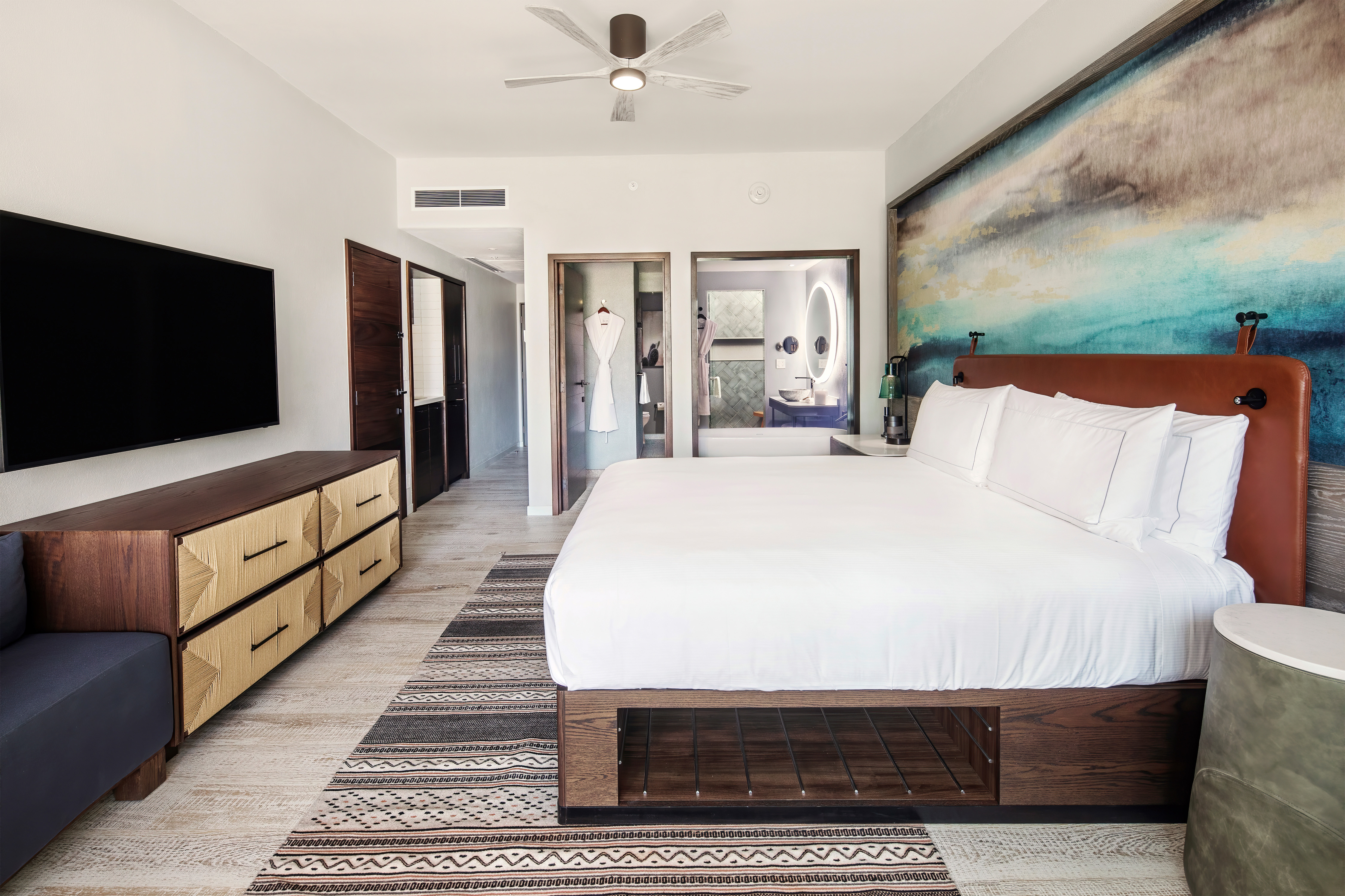 Large Bed HDTV  and View of Bathroom Area with Bathtub in Guest Room