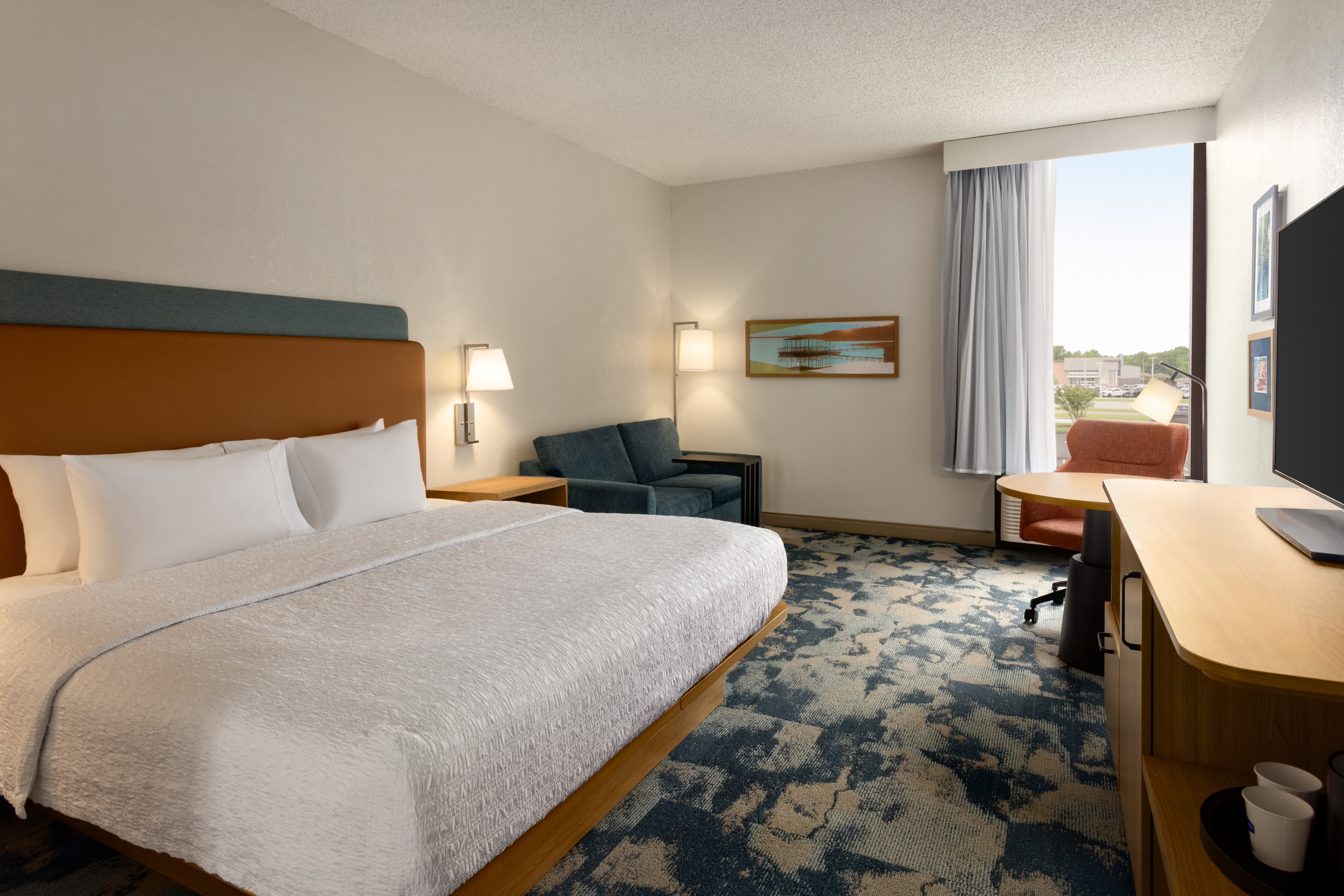 Spacious guest room with a large king bed and sofa bed