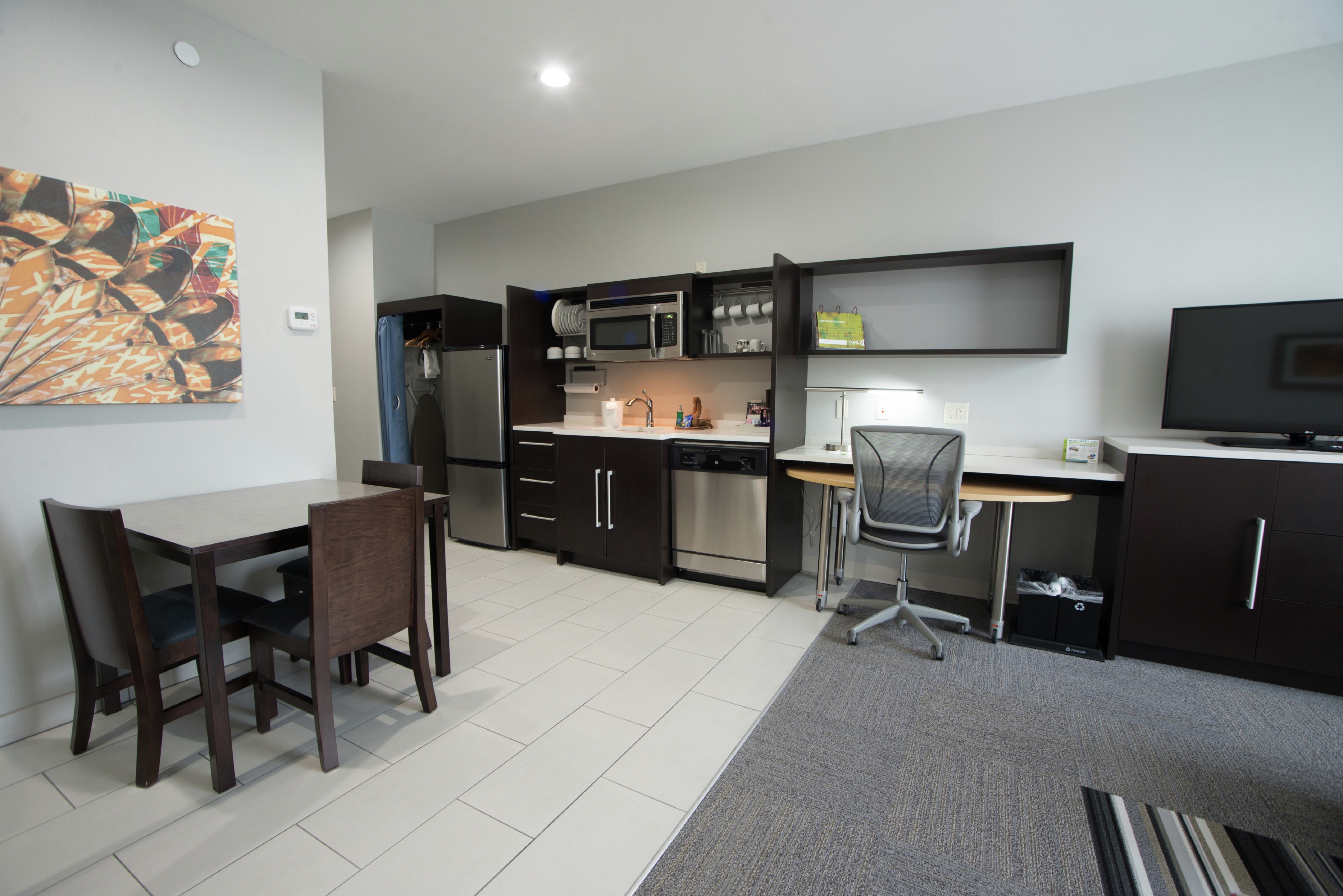 Seating For Three at Dining Table,  Kitchen Area, Work Desk, and TV in Studio Suite