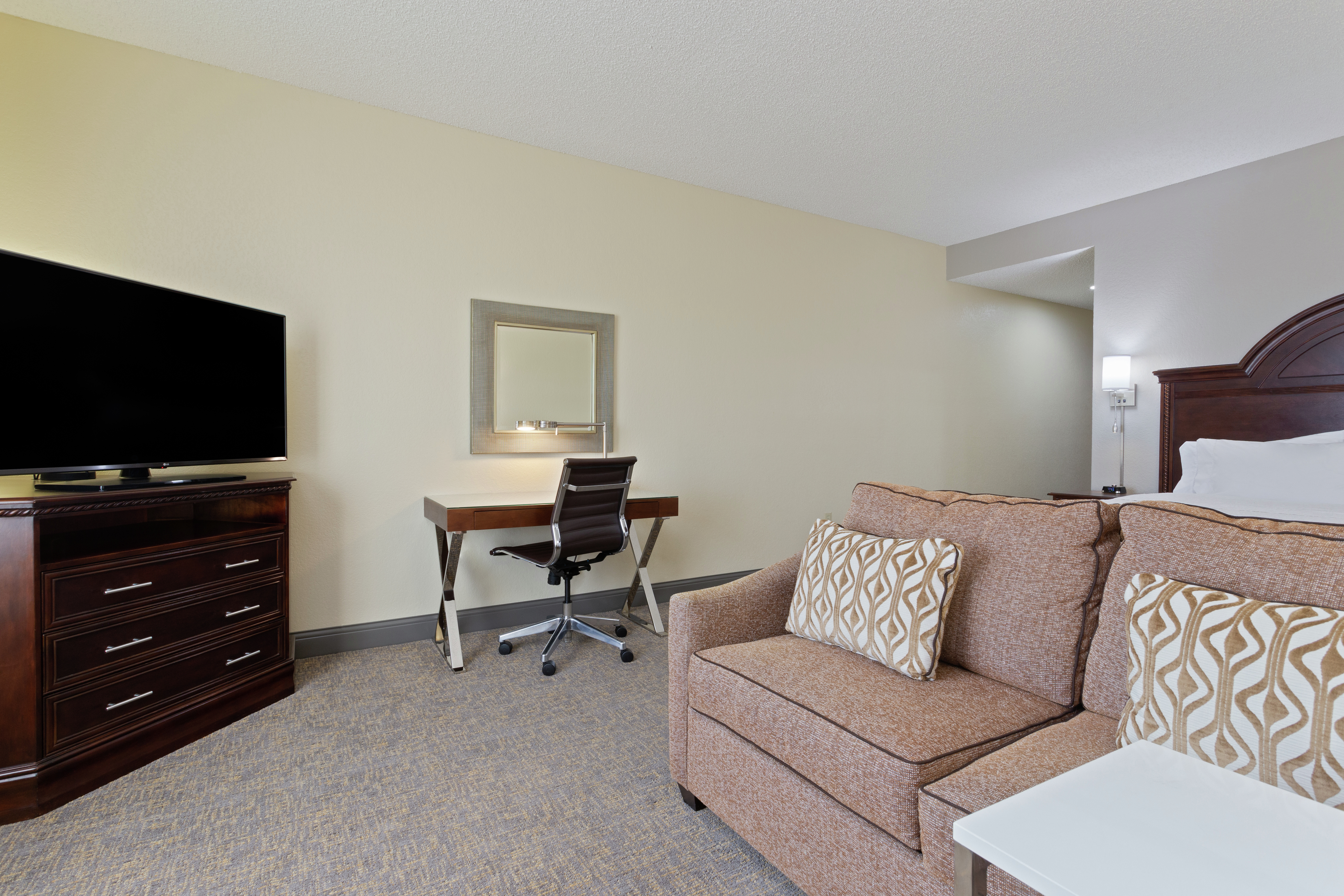 Sofa, TV, and Work Desk in King Deluxe Room