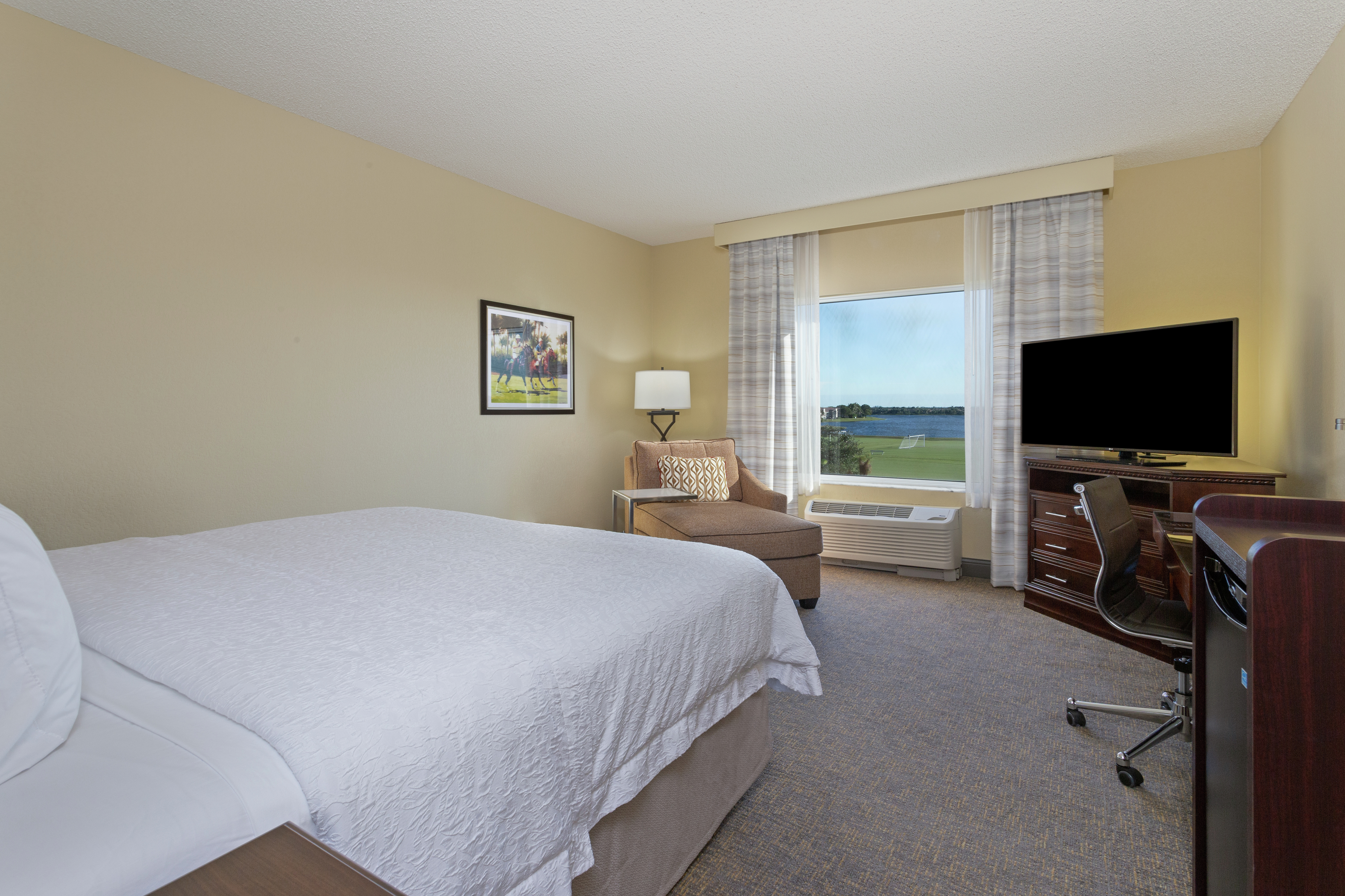 King Guest Room with Work Desk, TV, and Minifridge