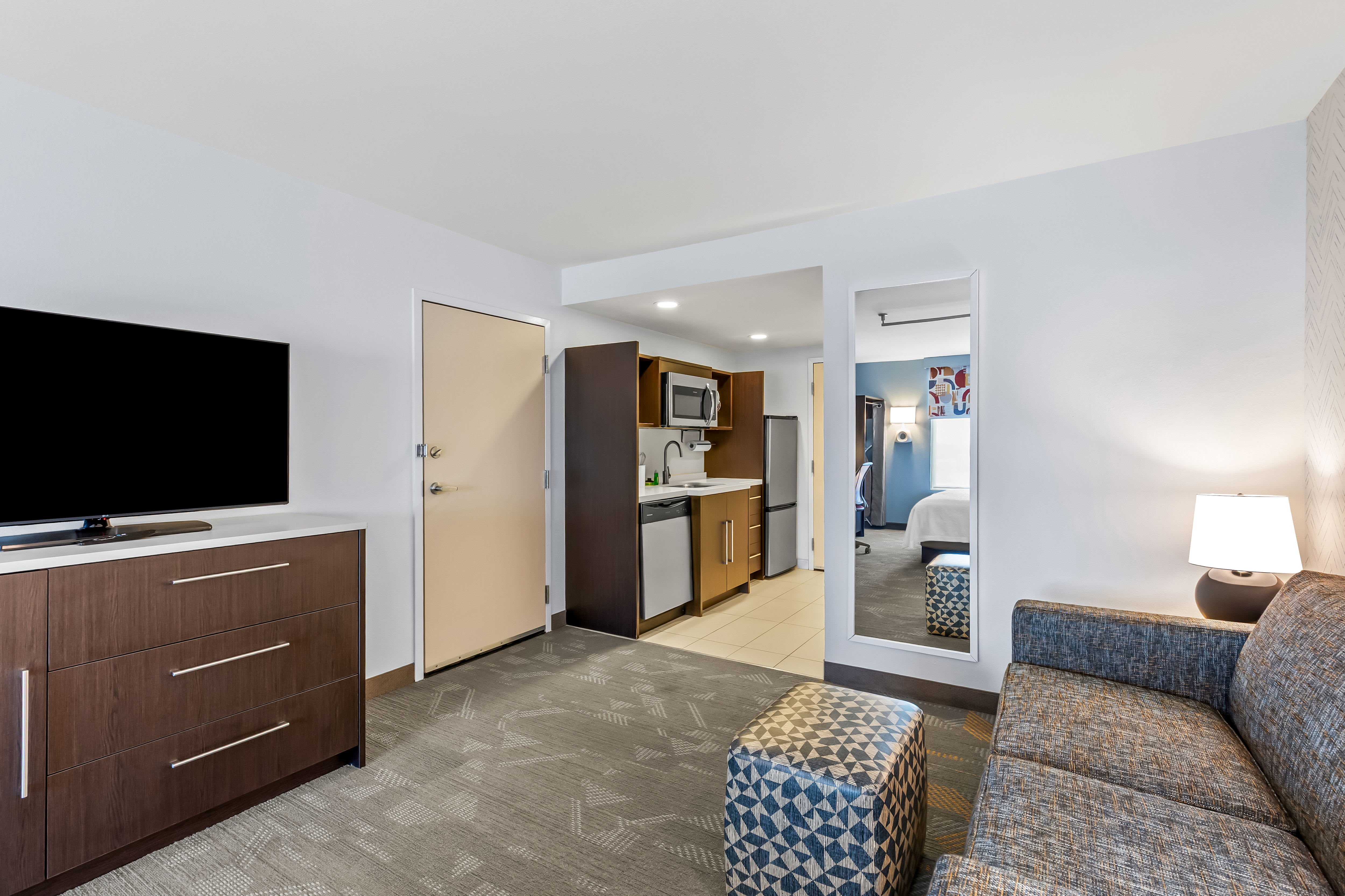 bedroom suite with lounge area and kitchen